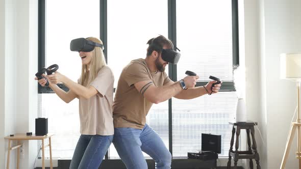 Couple in VR Helmet with Controllers