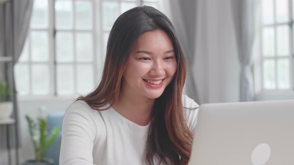 Asian Girl Use Laptop Computer And Smile alt