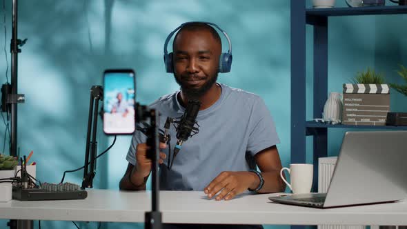 Vlogger Using Smartphone to Record Video for Vlog Channel alt