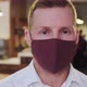 A Man Wearing Maroon Face Mask While Looking At The Camera Medical Stock Footage - VideoHive Item for Sale