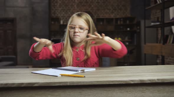 Angry Girl Throwing Books Out of the Table at Home alt