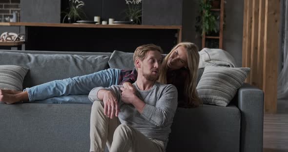 Smiling Marriage Couple Enjoying Weekend Leisure Activity Lying on Couch Together at Home alt