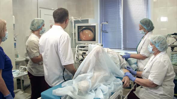 Doctors Conducting Procedure in Endoscopy Room alt
