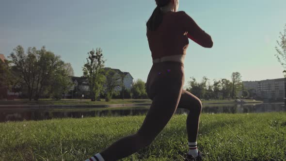 Girl practicing reverse lunges outdoors in the morning