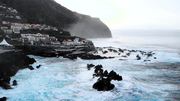 Drone Circle Around Natural Volcanic Swimming at Porto Moniz, Madeira island, Portugal