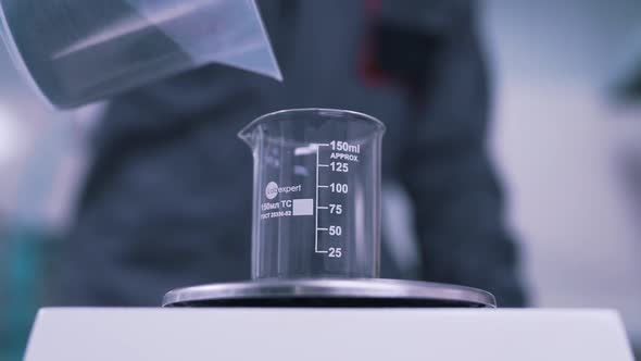 the Scientist Weighs the Material in the Lab