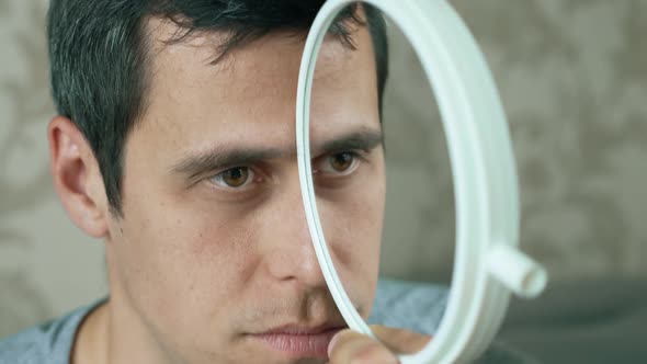 Man Makes a Funny Face Using a Mirror alt