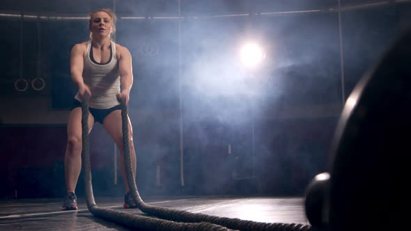 Female Athlete Training Using Battle Ropes Crossfit Workout Slow Motion