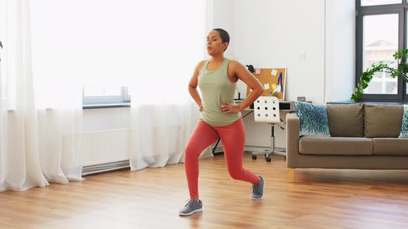 African Woman Doing Lunge Exercise at Home alt
