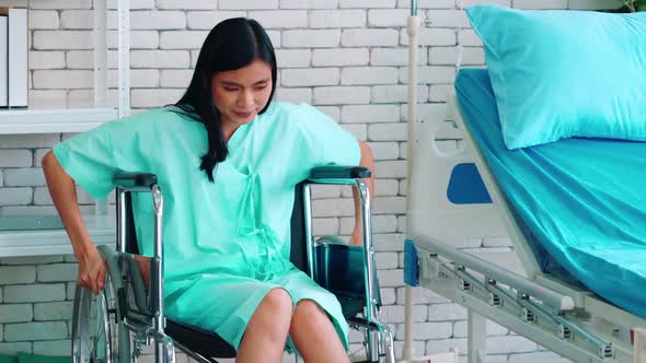 Young Happy Asian Woman on Wheelchair in a Hospital Ward alt