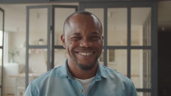 Cheerful African Guy Winking and Smiling Playfully alt