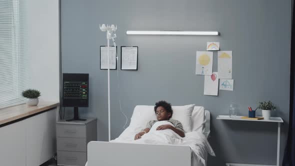 Unconscious Boy in Hospital Ward alt