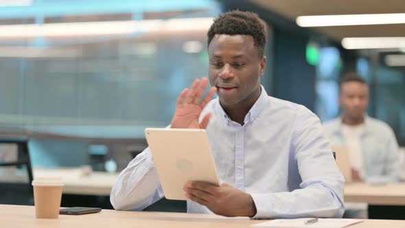 African Businessman Making Video Call on Tablet in Office alt