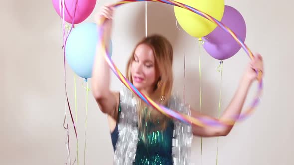 Blonde woman playing with hula hoop in photo booth alt