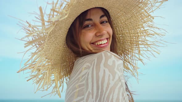 Closeup Face Smiling Woman Wearing Straw Hat at Beach in Sunshine Sunrise on Seashore alt