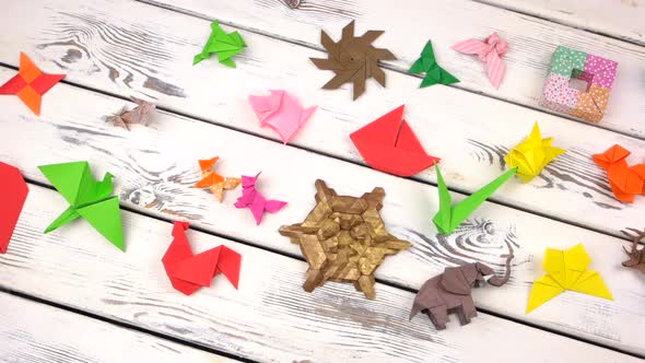 Set of Origami Objects on Rustic Wooden Background. alt