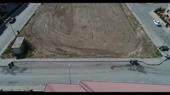 Construction of Aerial Top View on Pouring the Foundation for a New Building with Suburbs