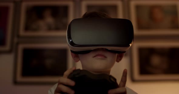 Young Boy Wearing Virtual Reality Headset and Playing Game