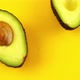 Rotating segments of a ripe and juicy avocado on an orange background. Slow motion. - VideoHive Item for Sale