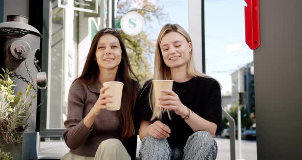 Two Friends Enjoy a Conversation with Tea and Coffee Glasses in Love Outside alt
