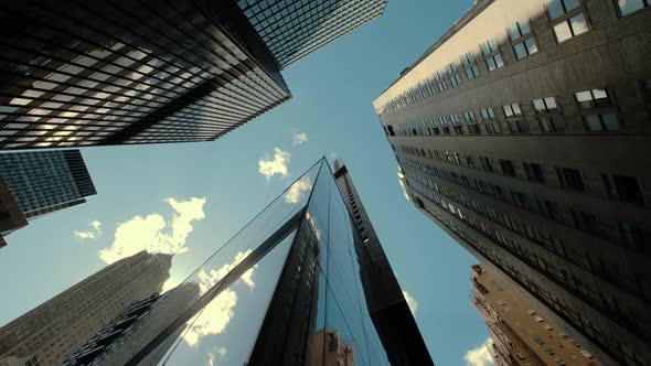 Bottom View of Pass By Several Skyscrapers in a Peaceful City Under the Cloudy Sky in Calm Day alt