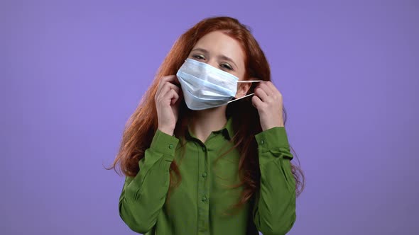 Pleased Woman Removed Protective Mask and Throws It on Floor As Symbol of Pandemic Epidemic End alt