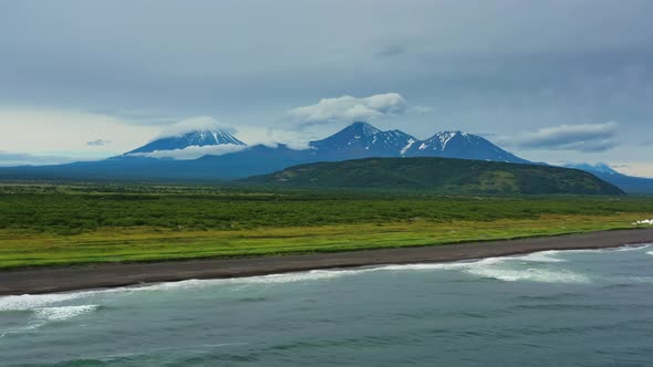 Beach with Black Sand and Volcano alt