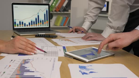 Business Partners Discussing Economic Situation of Company at Meeting in Office alt