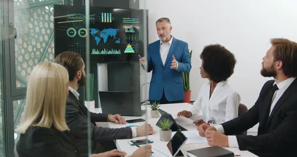 Mixed Race Ecological Experts Doing Presentation on Digital Whiteboard During Joint Meeting alt