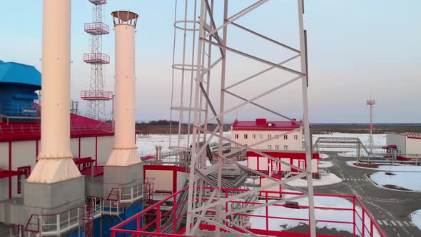The Drone Takes Off Near the Tower and Chimney of a Gas Turbine Power Plant That Generates alt