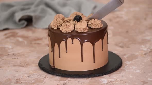 Pastry Chef Cuts Chocolate Cake with Knife