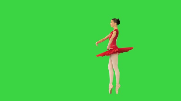 Young Ballerina in Red Classical Tutu Turns En Pointe and Makes a Reverence on a Green Screen Chroma alt
