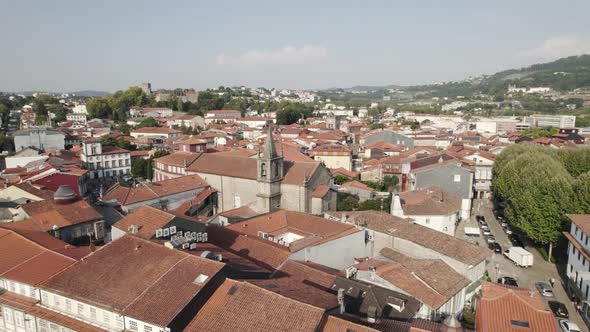 Aerial reveals tiled red roofs of medieval buildings; Guimaraes, Portugal