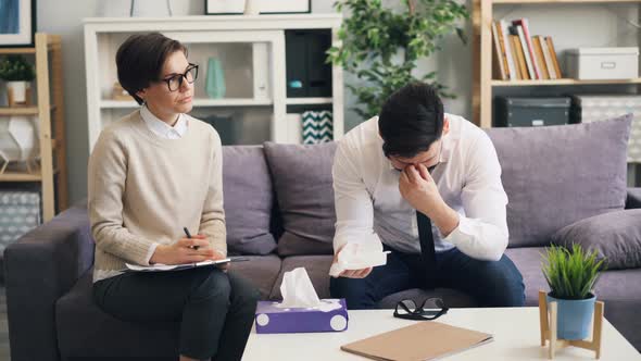 Desperate Guy Crying in Therapist's Office Talking About Troubles in Business alt