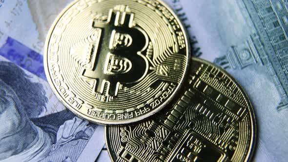 Bitcoin BTC coin rotate on 100 dollars USD bills. blockchain, mining GPU alt