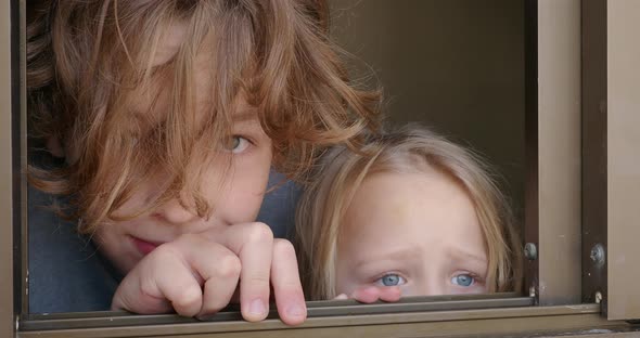 Brother with Junior Sister Looking Out of the Open Window alt