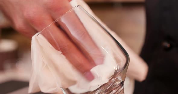 Extreme Closeup of a Male Hand Polishing the Empty Glass alt