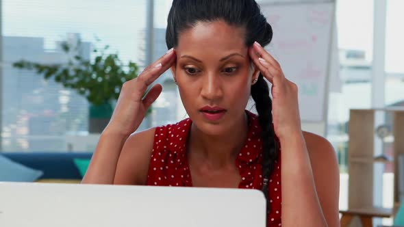 Depressed female executive sitting at desk 4k alt