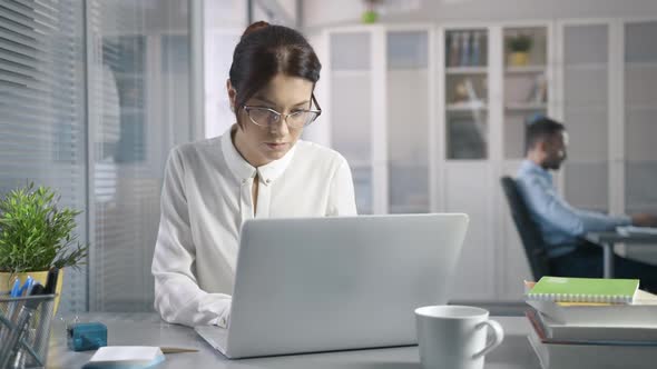 Cute 30s Sexy Female Working at Desk in Stylish Modern Business Office Using Computer for Email alt