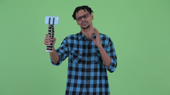 Happy Young African Hipster Man Vlogging and Showing Phone alt