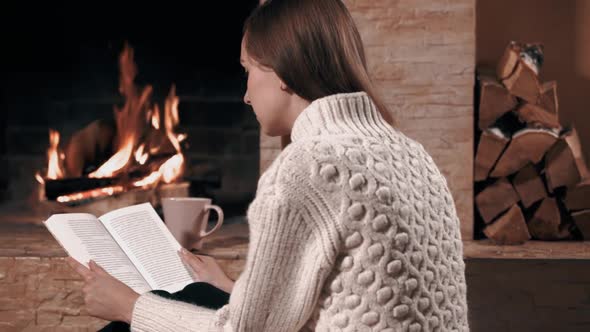 Girl Sitting Back and Reading Book at Home alt