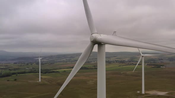 A close up of a wind turbine in a field alt