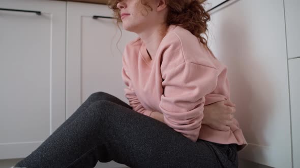 Video of young caucasian woman having a stomach ache because of eating disorder. alt