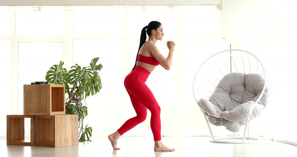 Athletic fit girl doing fitness aerobic exercises for booty in living room.