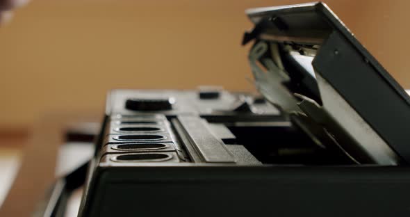 Male Hands Extract an Audio Cassette Into a Retro Tape Recorder alt