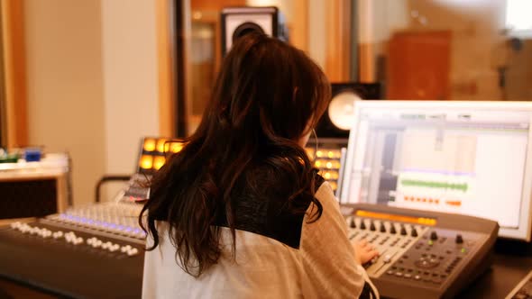 Female audio engineers using sound mixer alt