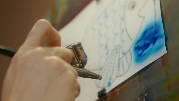 Woman Artist Learns to Paint with Airbrush with Acrylic Dye Paper and Easel alt