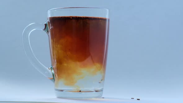 Soluble Coffee is Added to a Glass of Hot Water