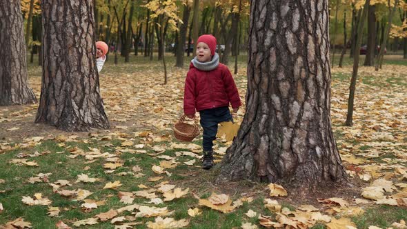 Two Happy Funny Children Kids Boy Girl Walking in Park Forest Enjoying Autumn Fall Nature Weather