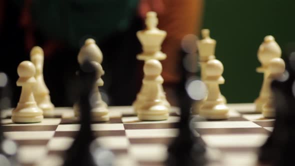 Chess board with a hand moving the white horse